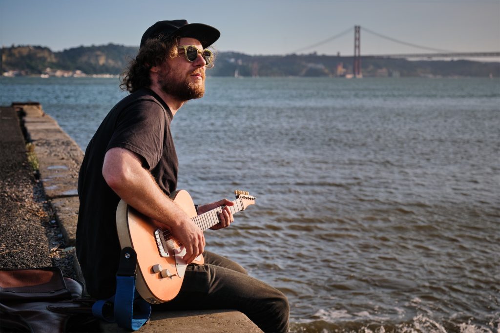 Street musician playing electric guitar in the street
