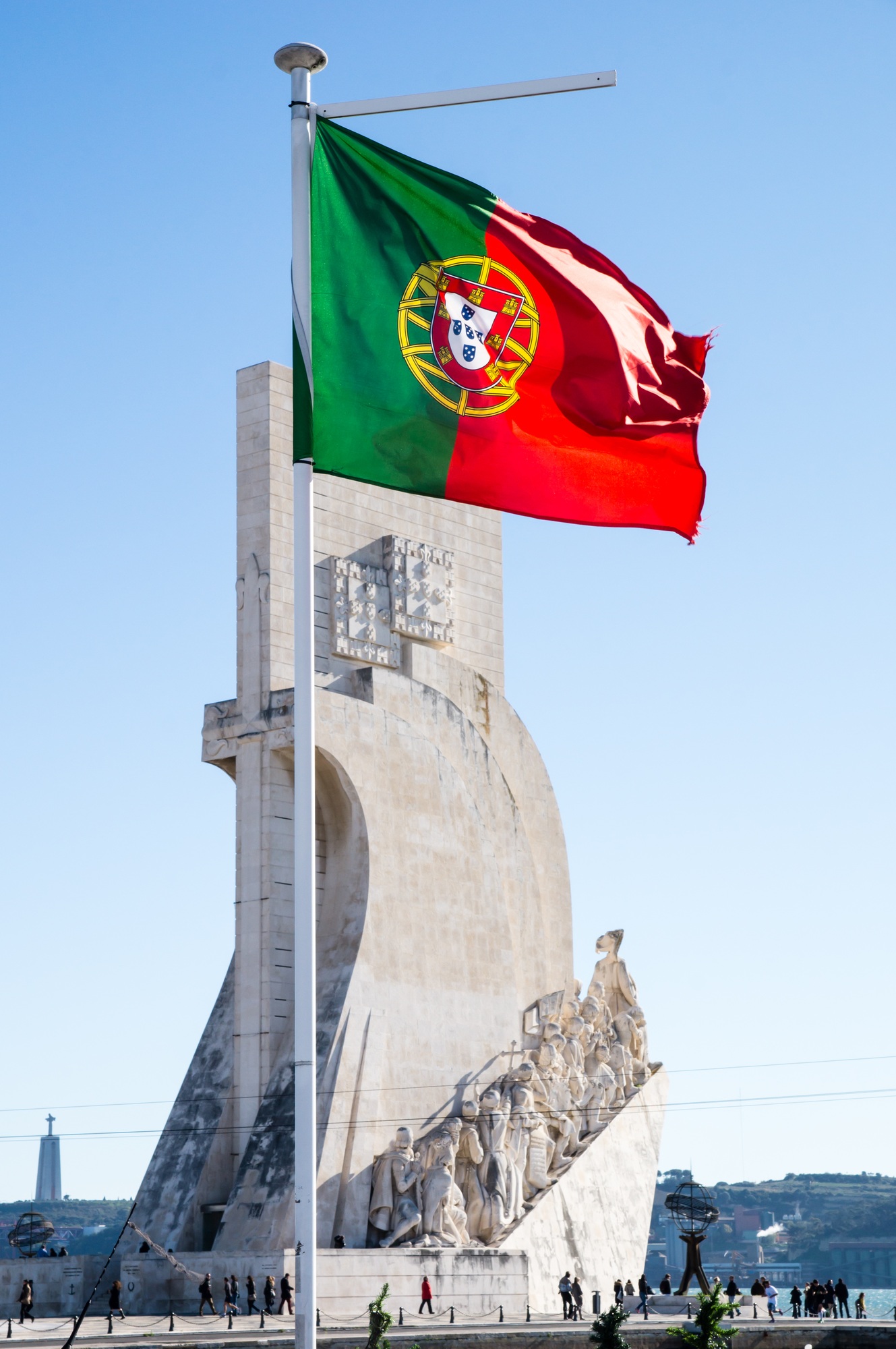 Vertical shot of the Portuguese flag on the medieval building background in Lisbon