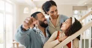 Parents, girl and happy with keys in new home or apartment, relocation and property purchase for in